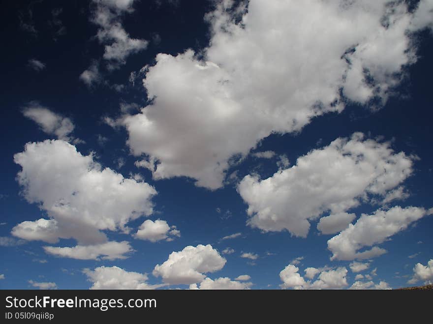 Fluffy clouds fill the blue sky above Namibia. Fluffy clouds fill the blue sky above Namibia