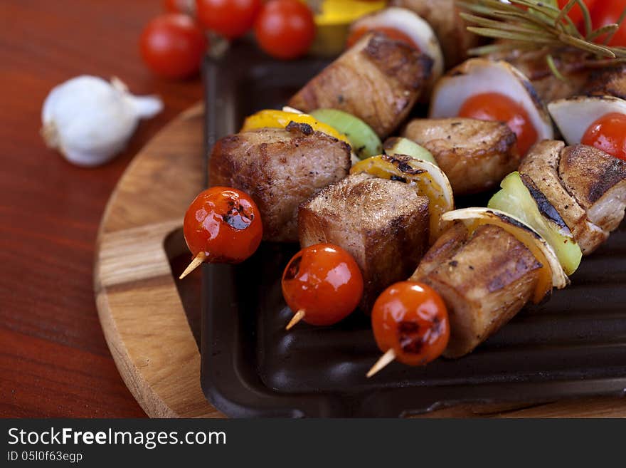 Meat and vegetable skewers on plate