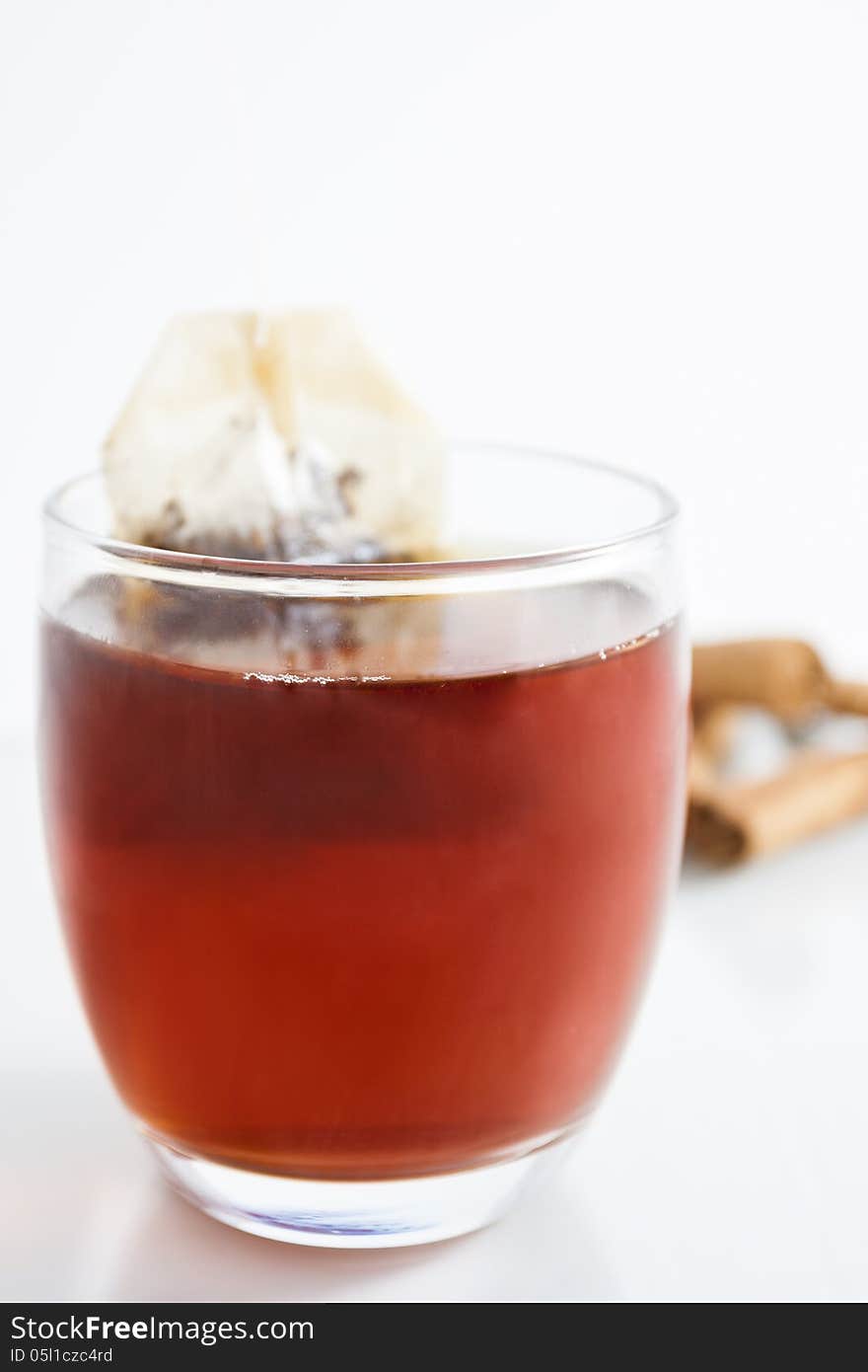 Cup of red tea with cinnamon from above with white background. Cup of red tea with cinnamon from above with white background