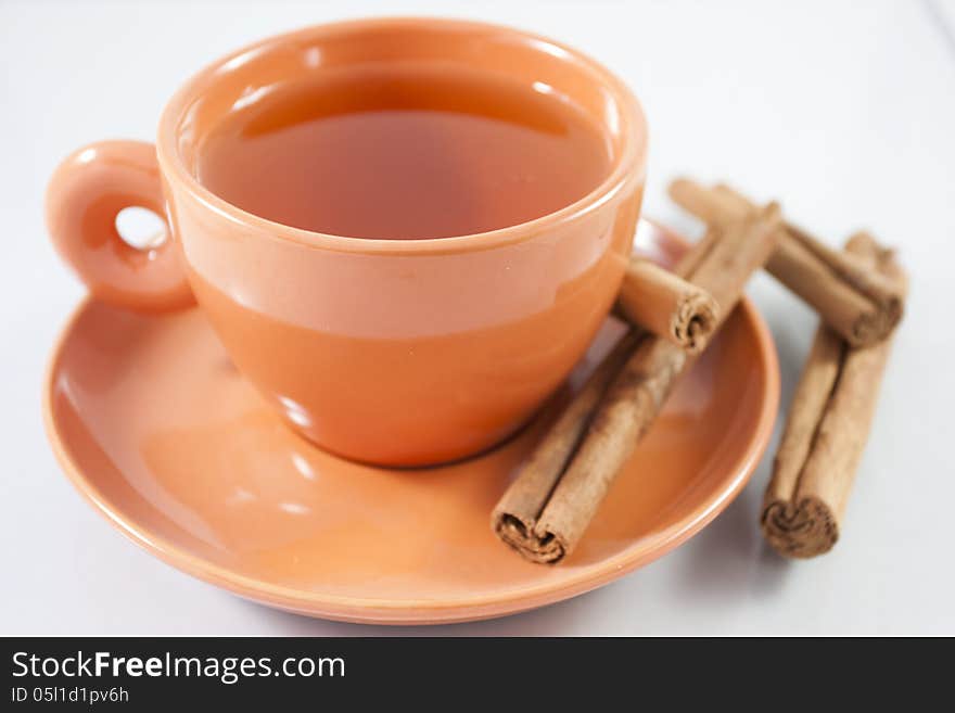 Cup of red tea with cinnamon from above with white background. Cup of red tea with cinnamon from above with white background