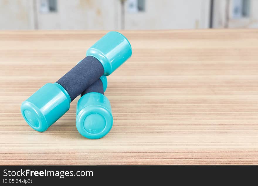 Samall Fitness dumbbells on the desk wooden