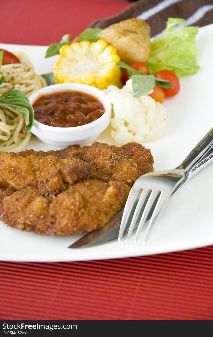 Fried chicken dish on red background