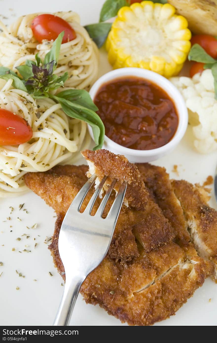 Piece of fried chicken on fork