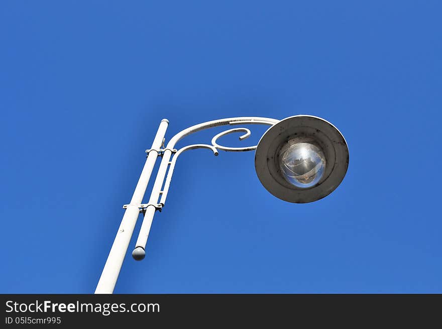 Street white iron lamp on blue sky. Street white iron lamp on blue sky.