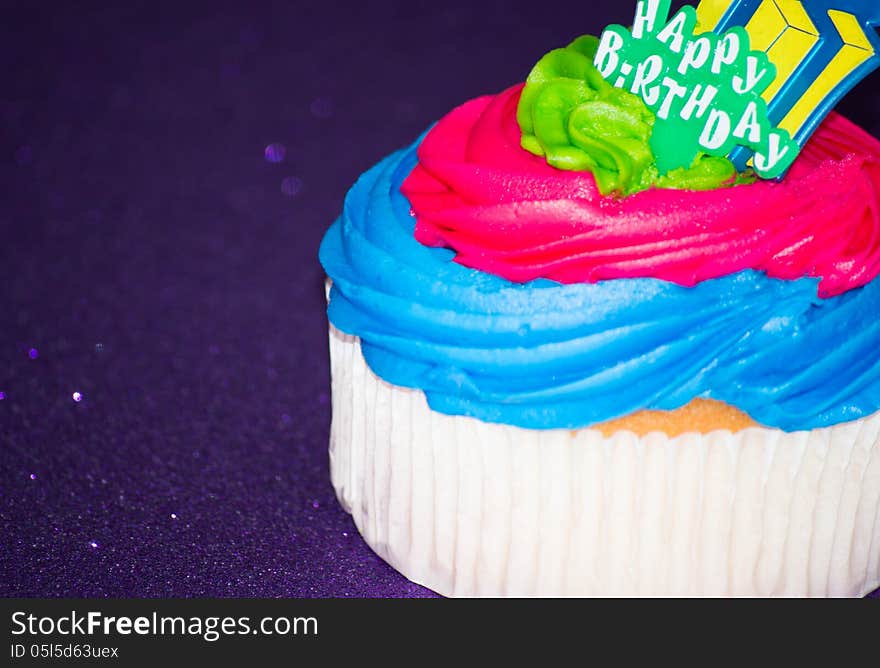 Colorful cupcake on a purple background