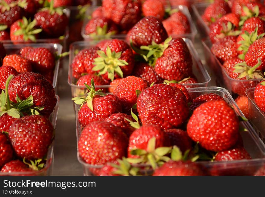 Fresh containers of strawberries at the local outdoor market. Fresh containers of strawberries at the local outdoor market