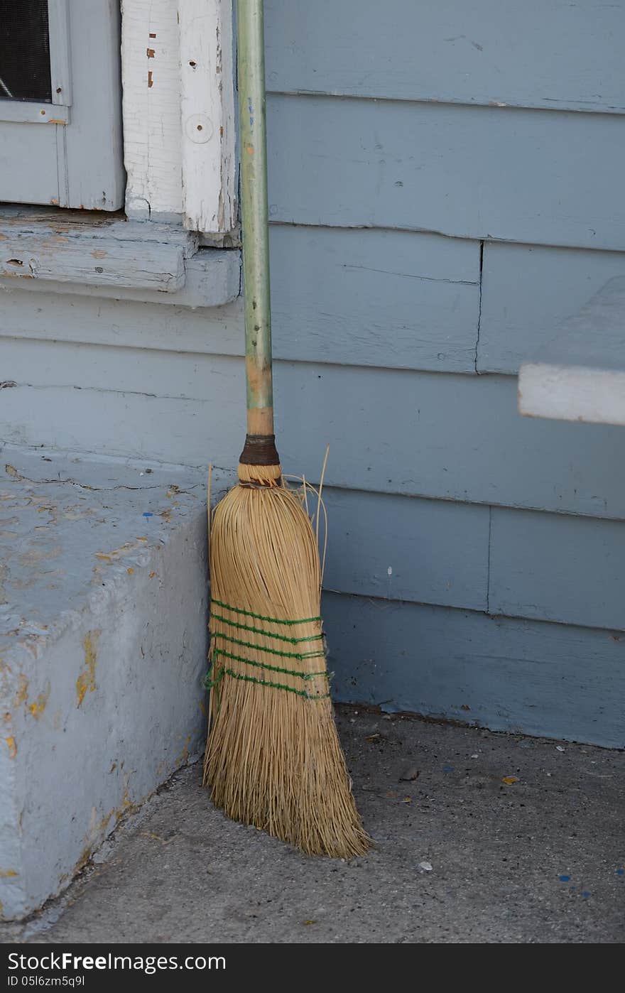 Old Broom By Building