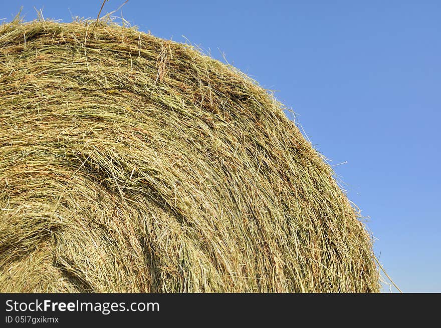 Closeup on straw bale under blue sky