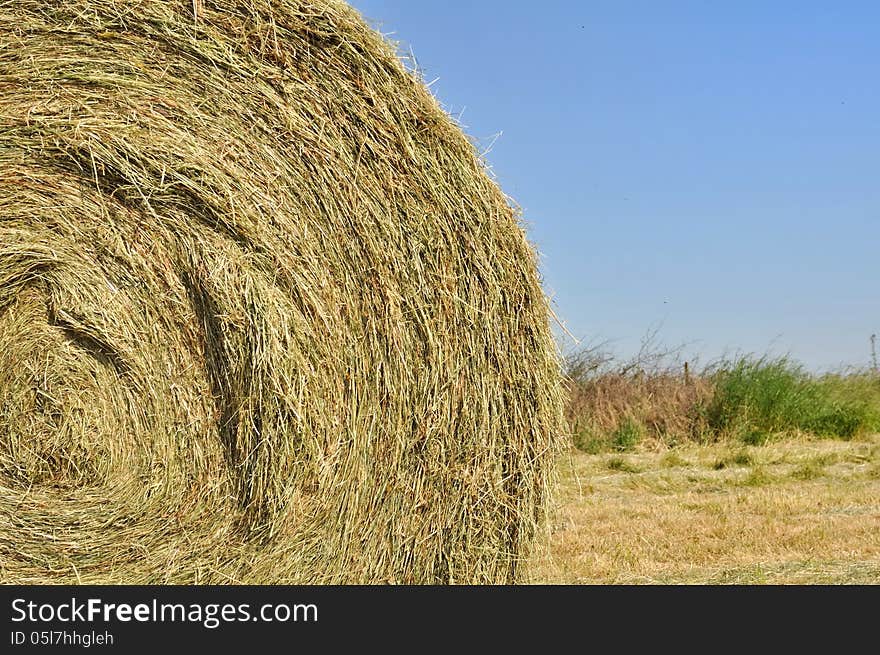 Closeup on straw bale under blue sky