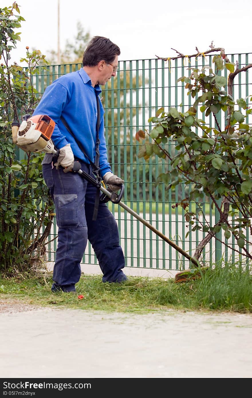 A farmer while doing some brush cutting