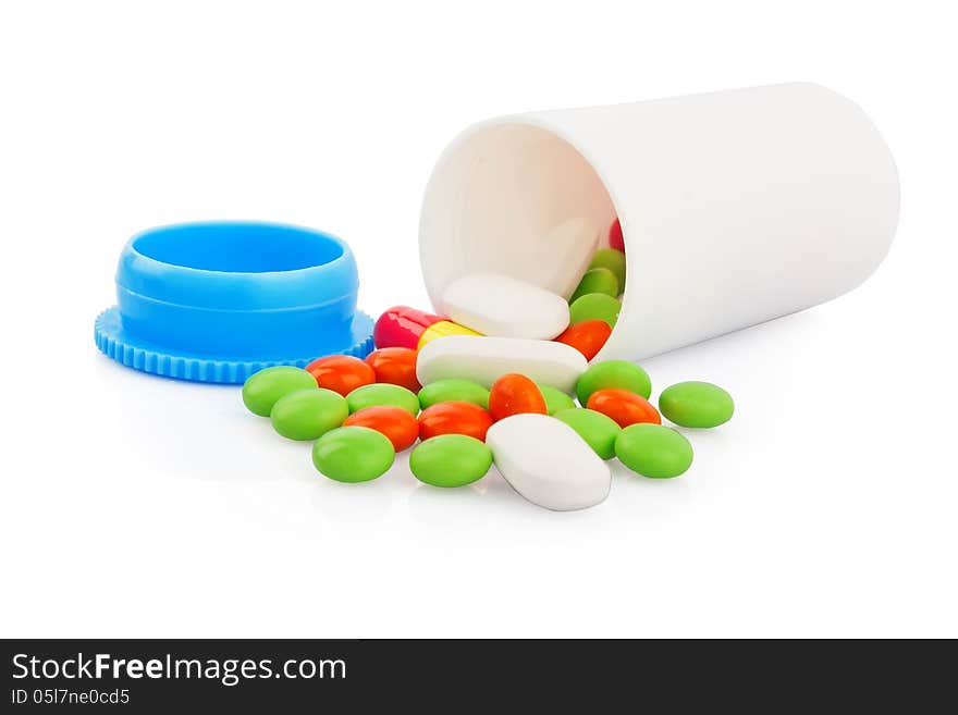 Pills spilling out of pill plastic bottle on white, medical photo. Pills spilling out of pill plastic bottle on white, medical photo