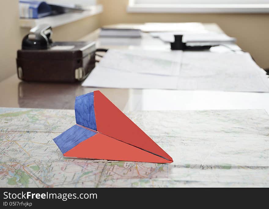 Paper plane on the aerial map