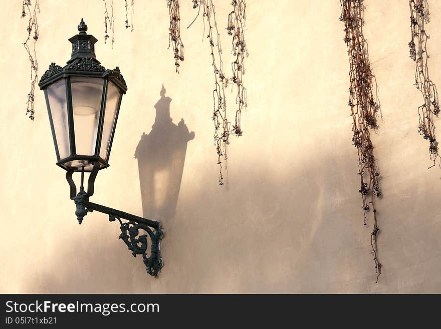 Old street lamp on a brown wall. Old street lamp on a brown wall.