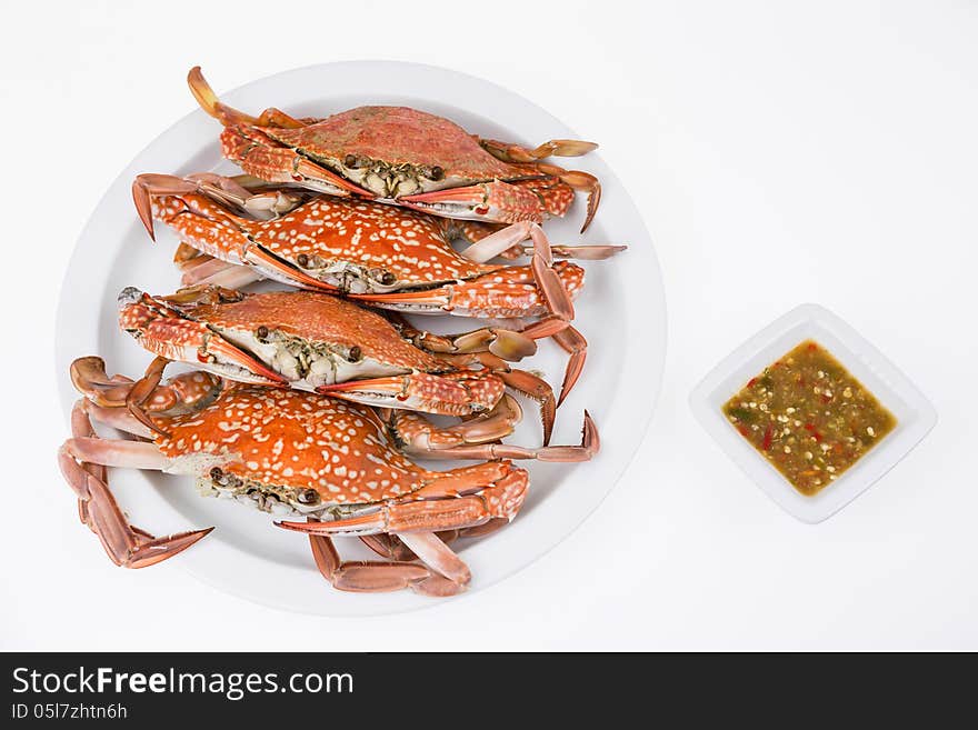 Steamed crabs with seafood sauce on white background