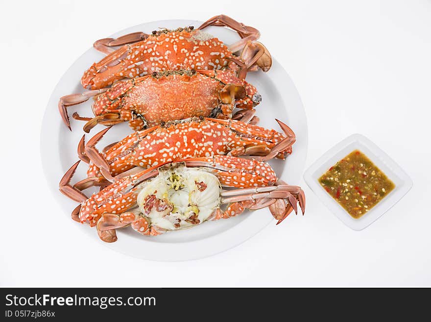 Steamed crabs with seafood sauce on white background