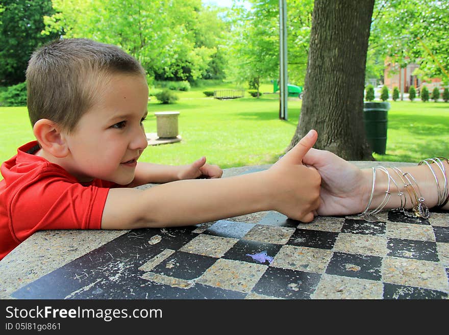 Young Boy Determined To Beat His Mom At Thumb Wrestling