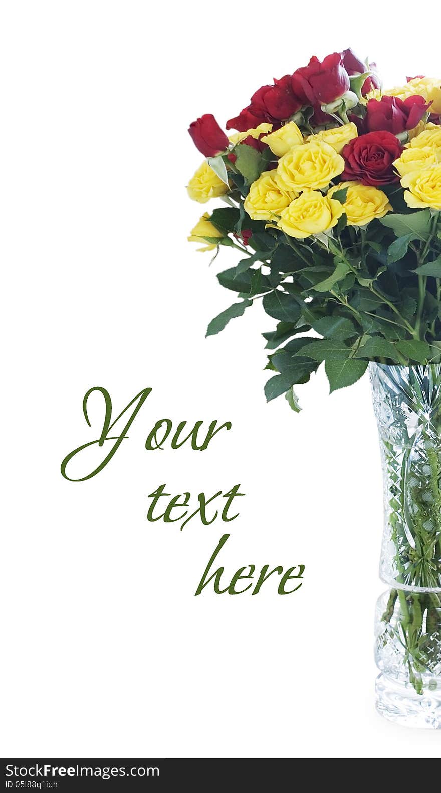 A large bouquet of purple and yellow roses in a crystal vase. A large bouquet of purple and yellow roses in a crystal vase