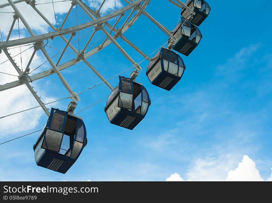 A part of ferrie wheel on a background of blue skies. A part of ferrie wheel on a background of blue skies