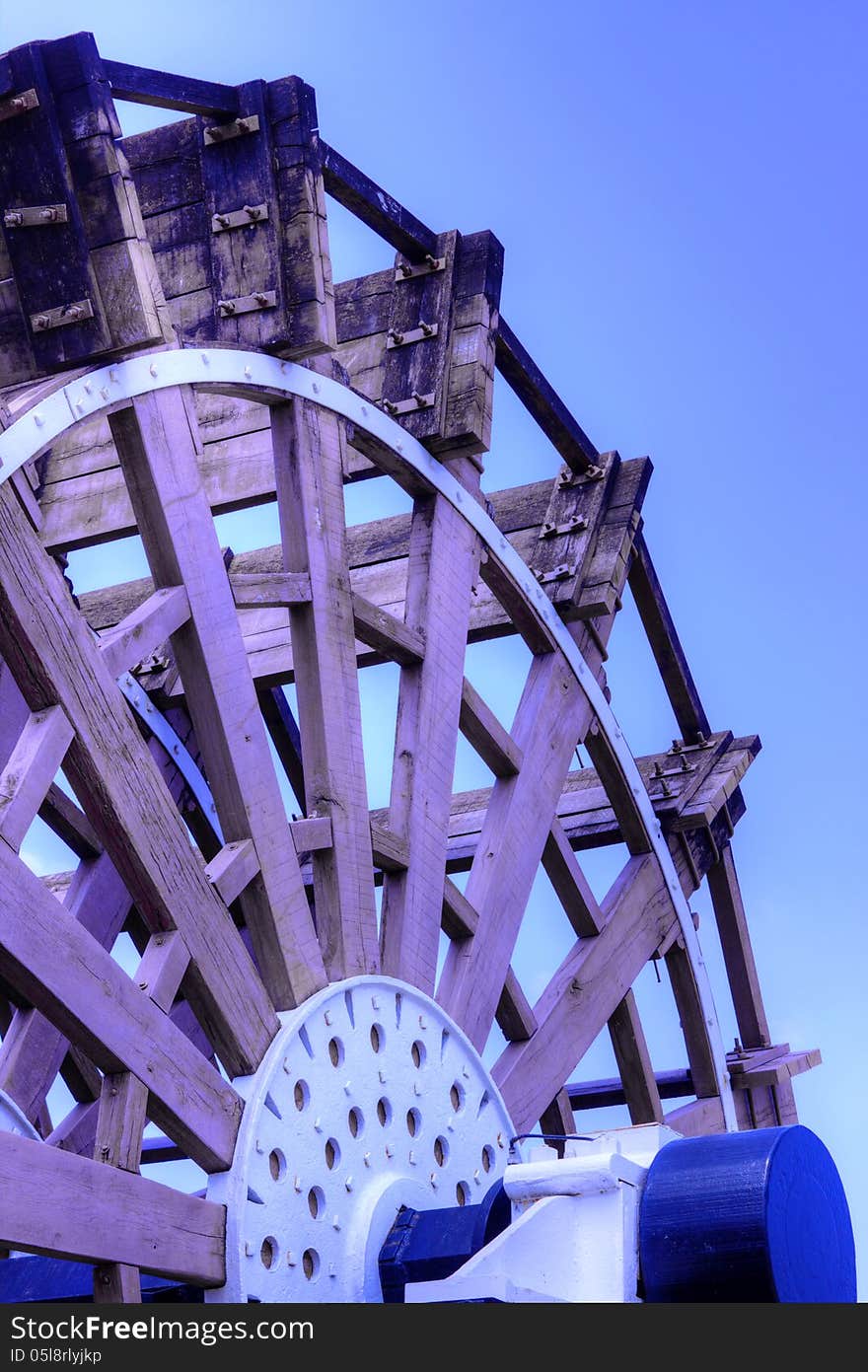 Wood mill water wheel against blue sky. Wood mill water wheel against blue sky