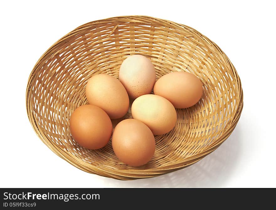 Brown eggs on a wicker basket.