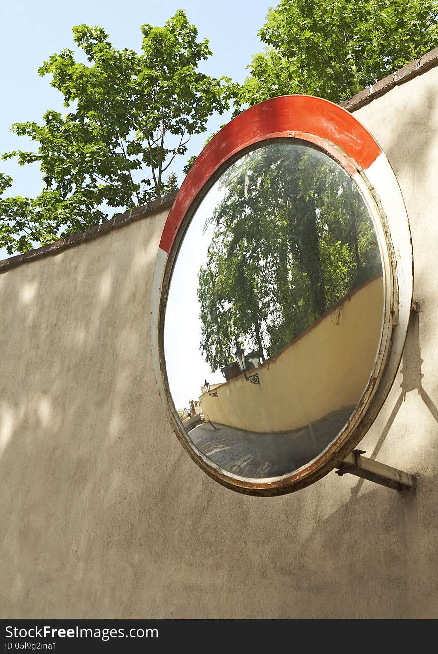 Reflection of street in road mirror.