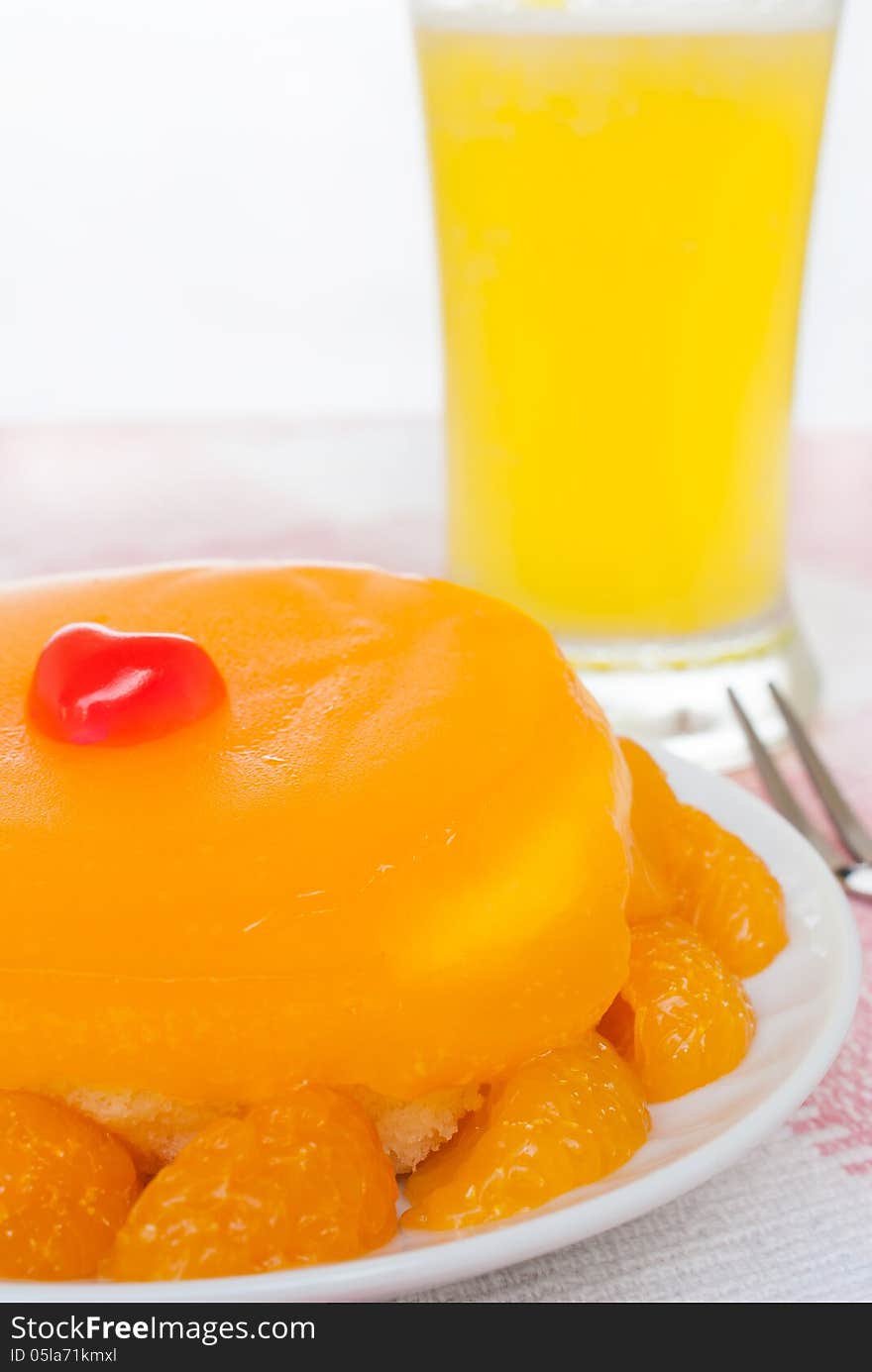 A fresh Orange cake with orange segments on plate