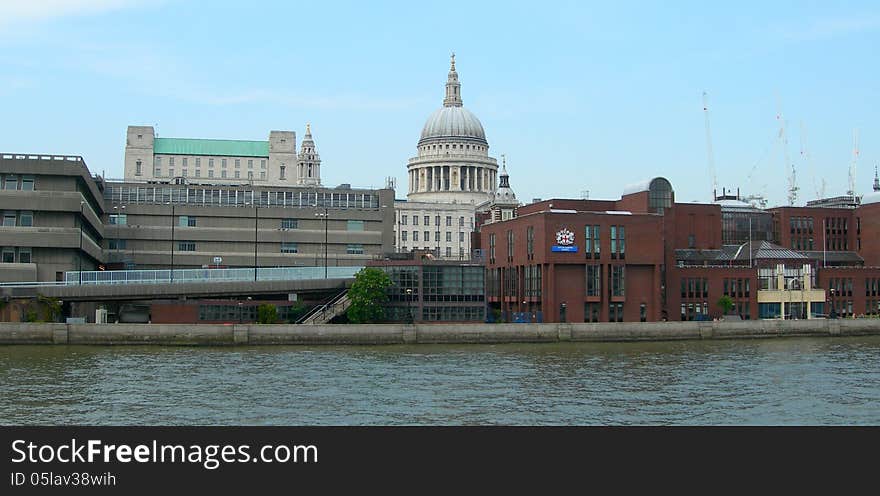 Modern and classic architecture with St Pauls cathedral as background, along the river Thames in London, UK. Modern and classic architecture with St Pauls cathedral as background, along the river Thames in London, UK