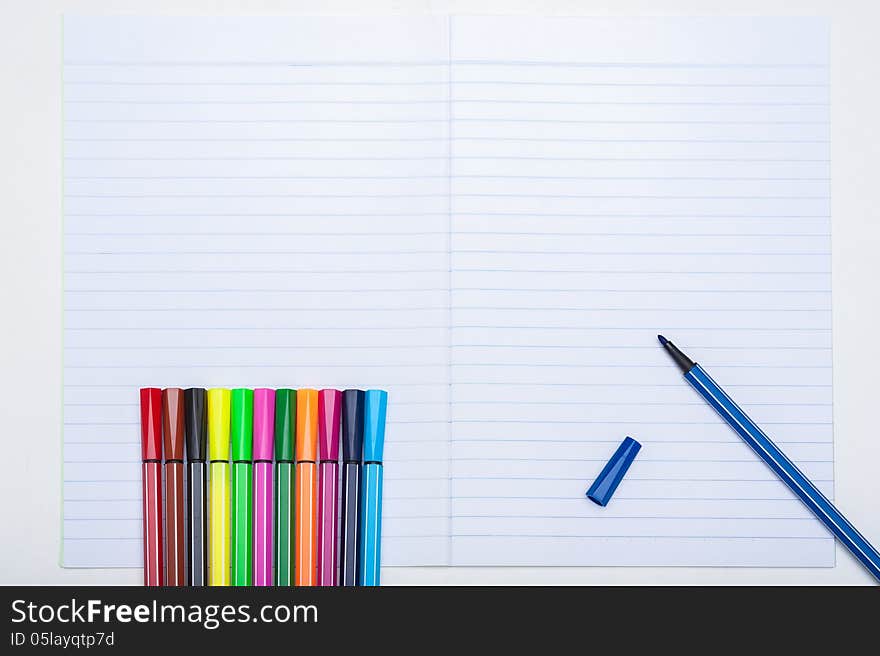 Colors and notebook on the desk