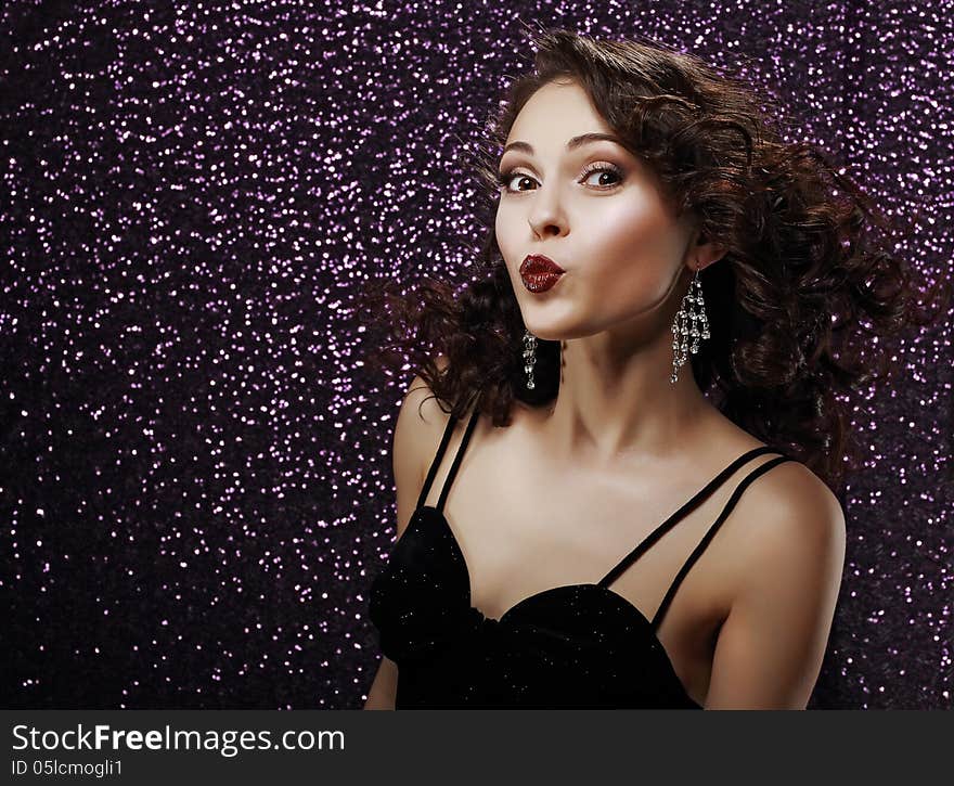 Coquette. Playful Young Woman Blowing a Kiss. Frizzy Hair