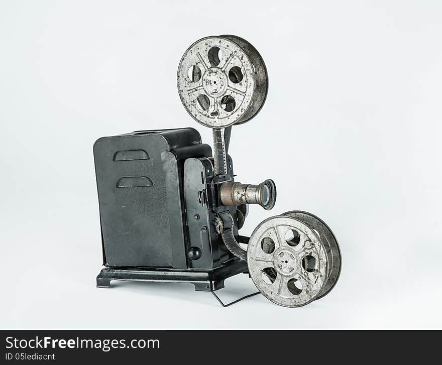 A retro cine camera on a plain grey background. A retro cine camera on a plain grey background