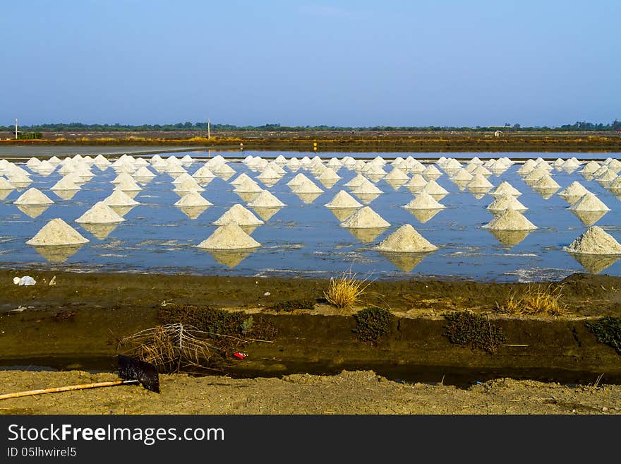 Pile of salt in the salt pan at rural area of Thailand. Pile of salt in the salt pan at rural area of Thailand.