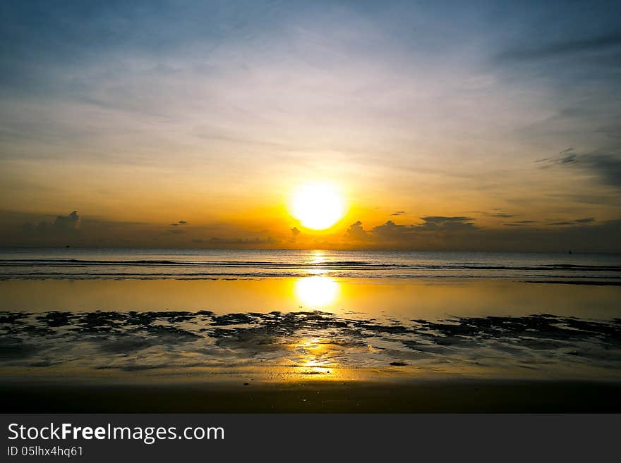 Sunrise over the beach at low tide