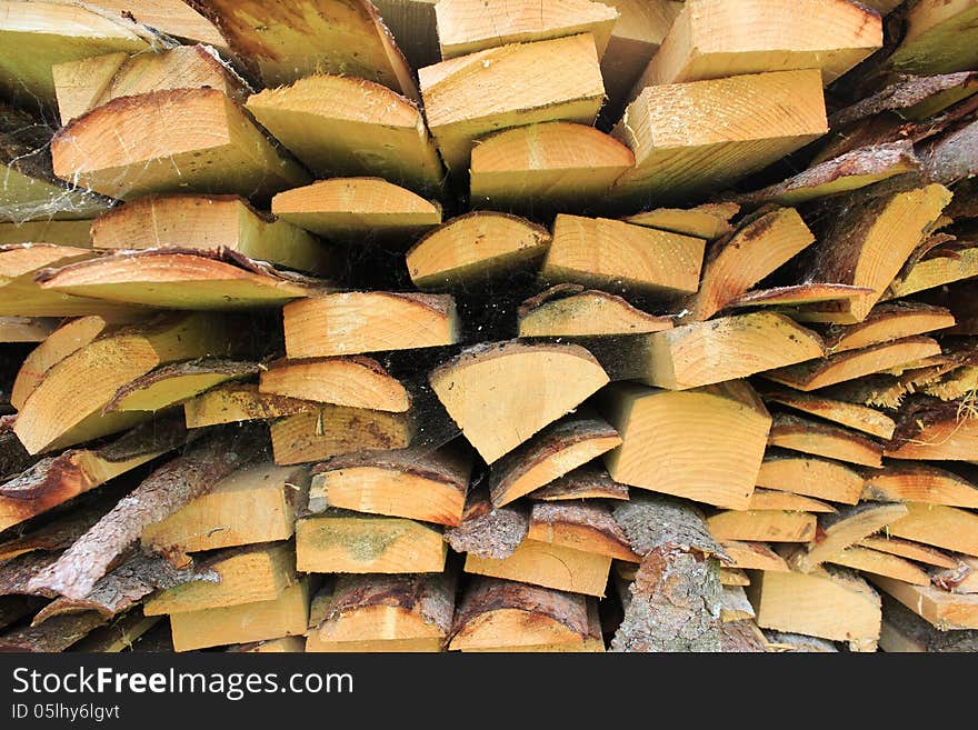 Various wood firewood stacked in a pile. Various wood firewood stacked in a pile