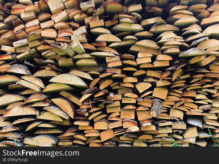 Various wood firewood stacked in a pile. Various wood firewood stacked in a pile