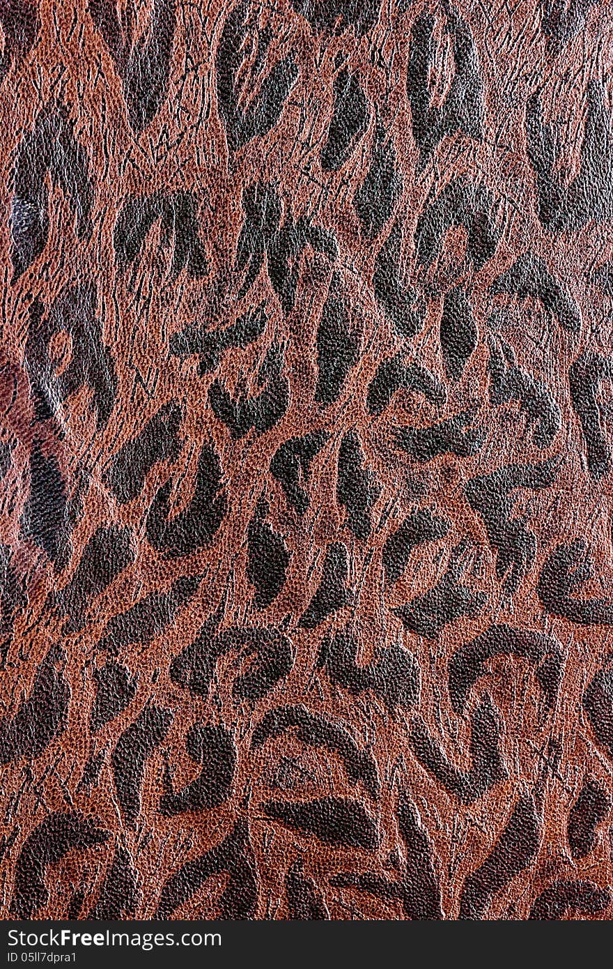 Brown leather background with a darker brown design