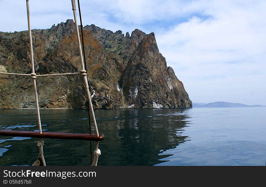 Floating Along Mountainous Coast On The Sea