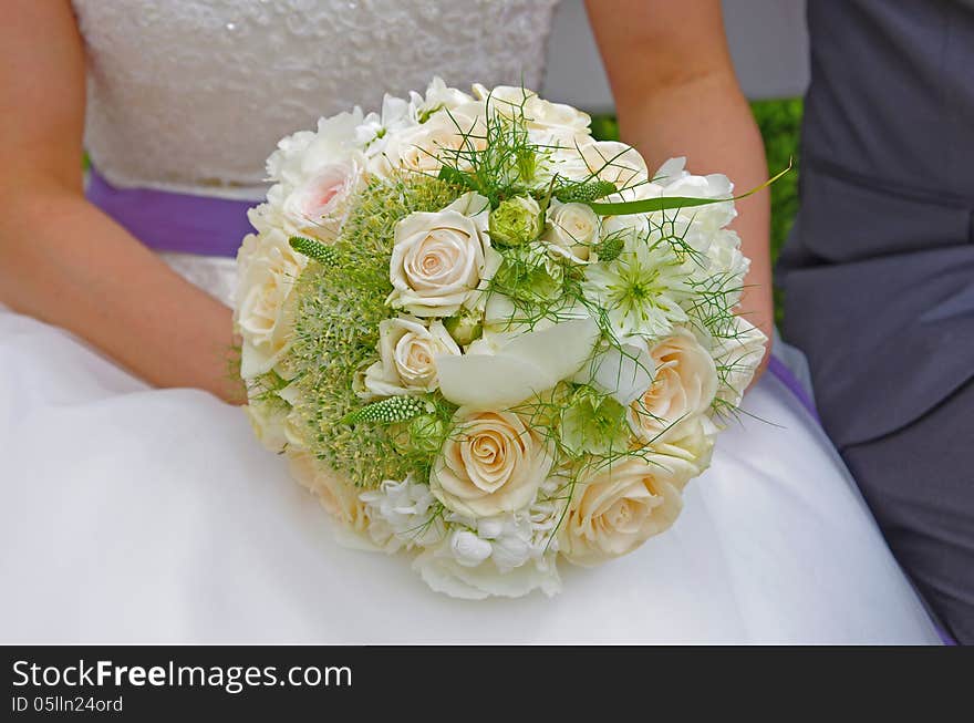 Bride holding wedding bouquet in her hands