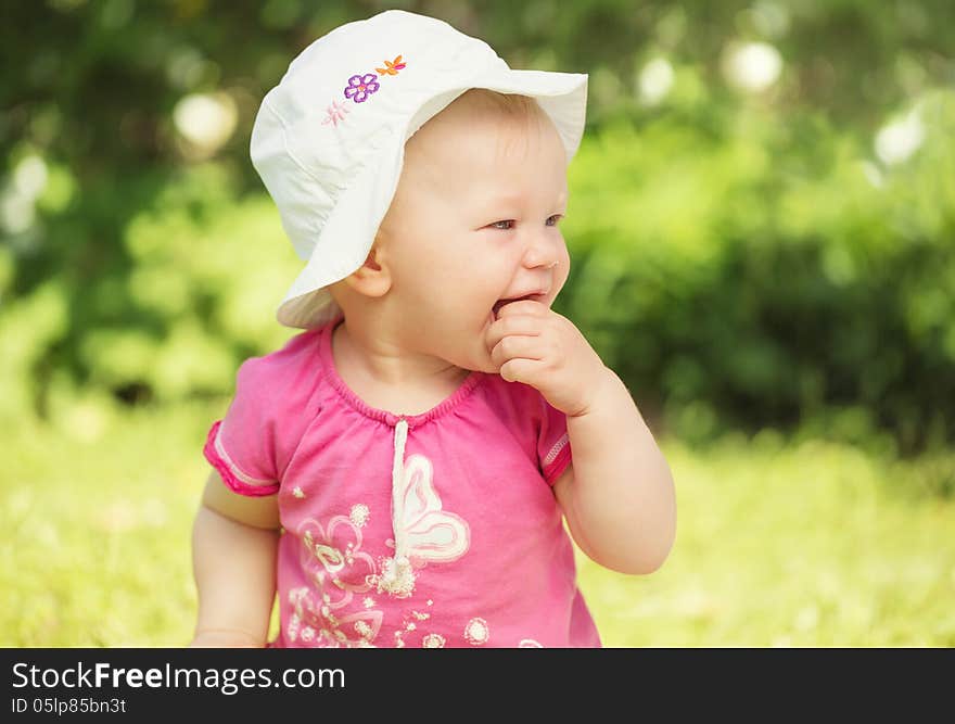 Portrait of cute little baby girl smiling in the garden. Portrait of cute little baby girl smiling in the garden