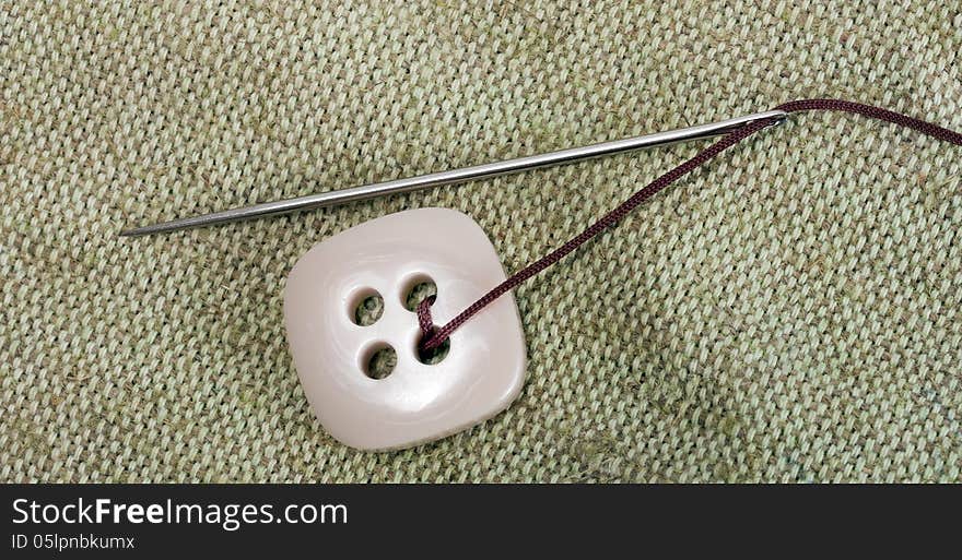 Sewing needle and thread with buttons background