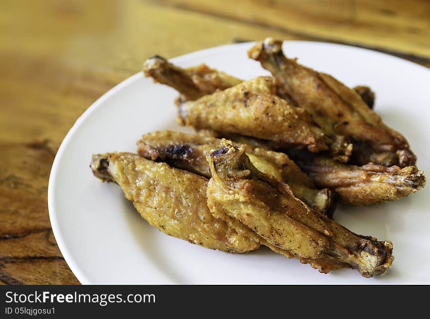 The fried chicken in the white plate