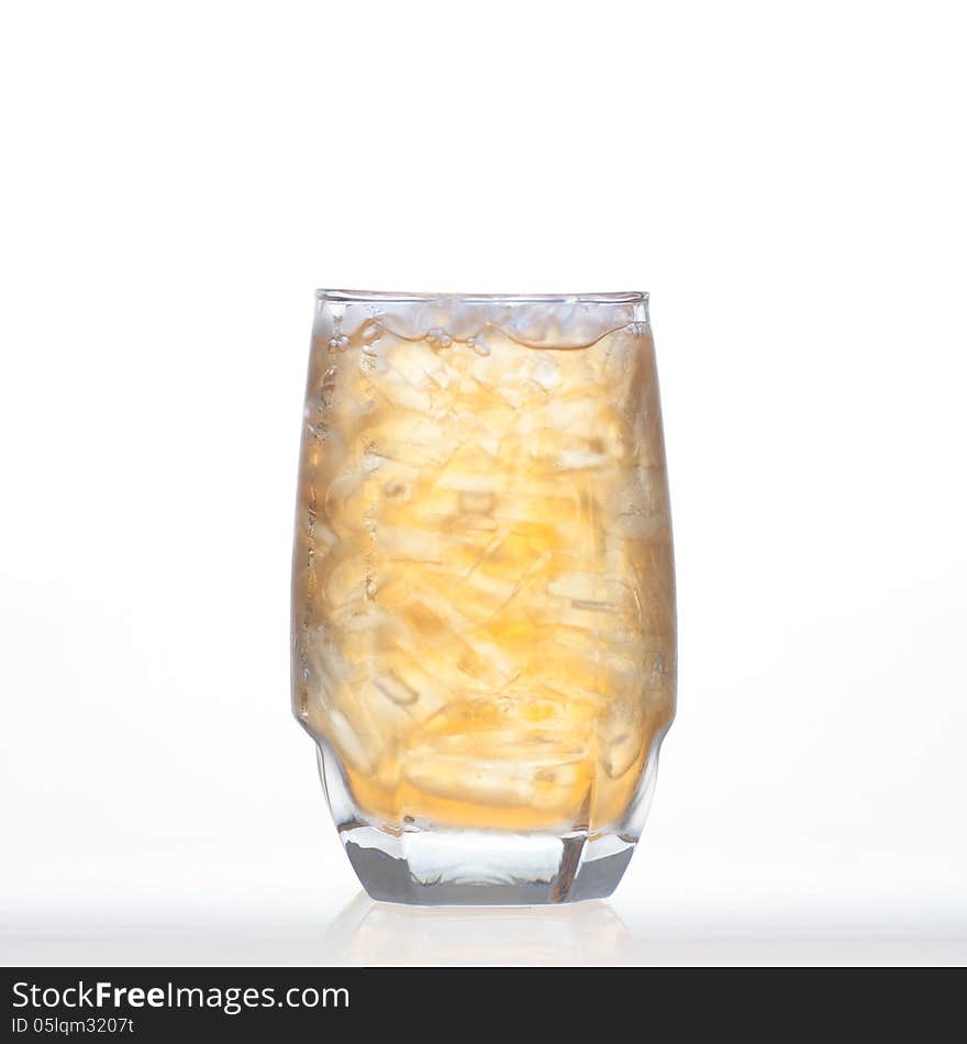 Sweet and refresment bael tea cold drinks with ice in glass on white background