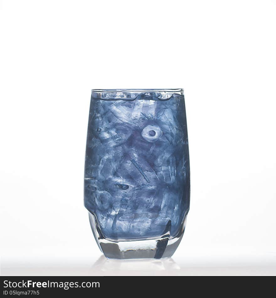 Butterfly pea Thai herbal drinks with ice in glass on white background