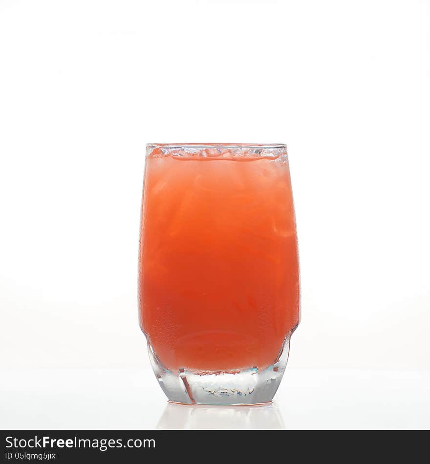 Carrot herbal drink in glass on white background. Carrot herbal drink in glass on white background