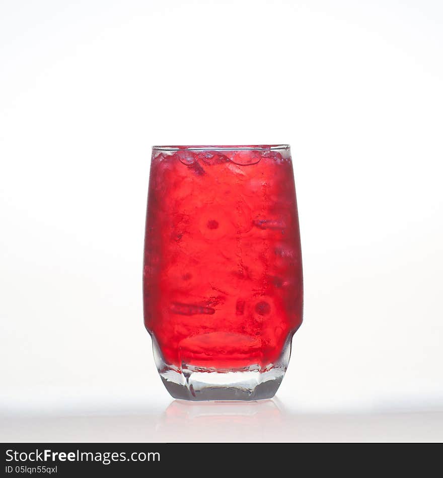 Red fruit flavour soft drinks with soda water on white background