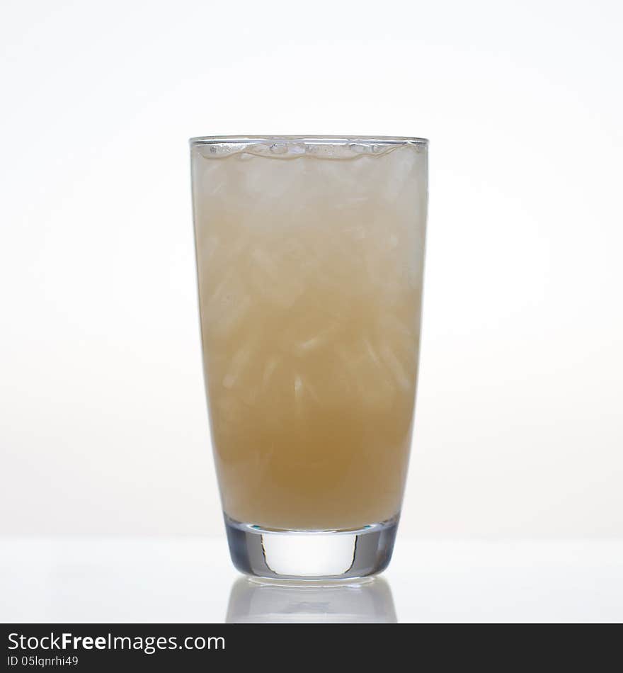 Fresh and cold passion fruit juice in glass on white background