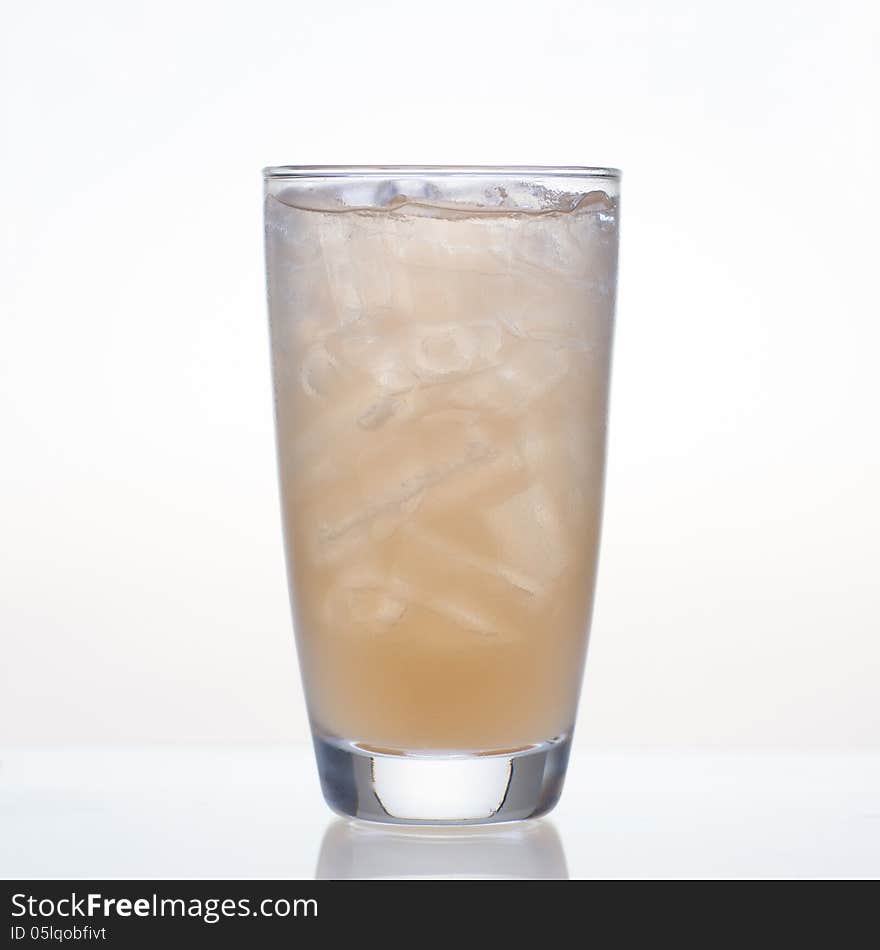 Fresh and cold tamarind fruit juice in glass on white background