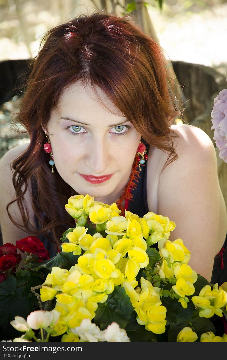 Close up of young beautiful woman near the flowers. Close up of young beautiful woman near the flowers.