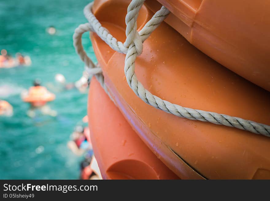 Life buoy with people swimming in the sea