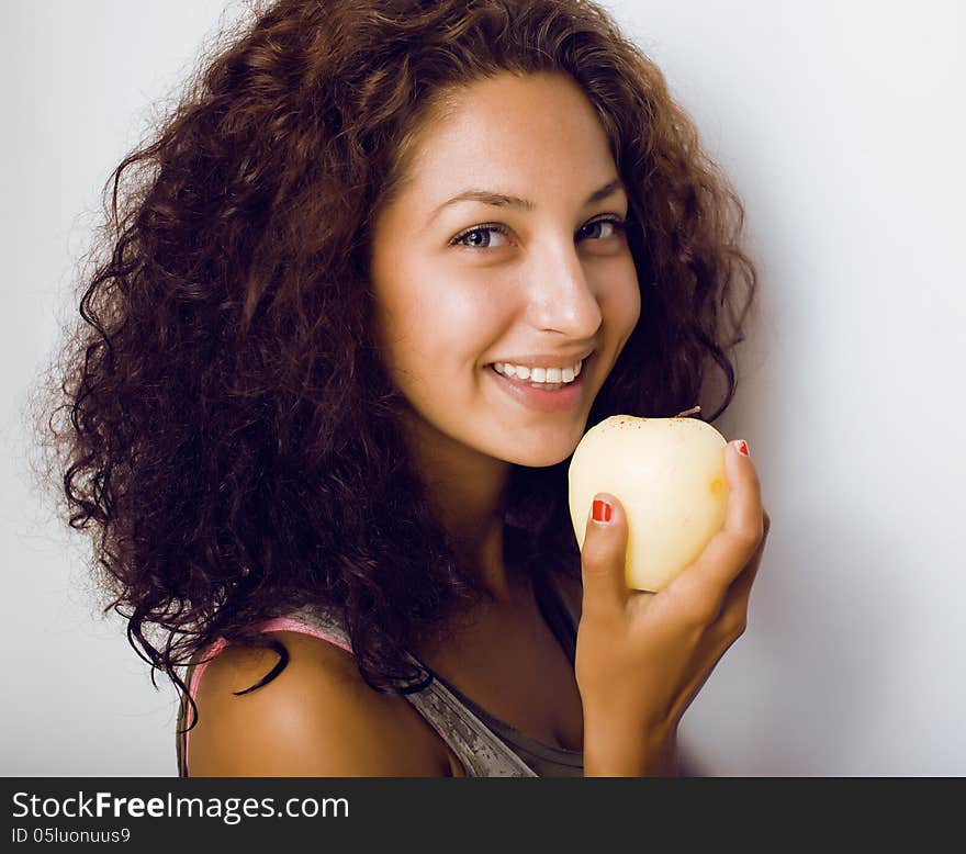 Portrait of cute little girl with green apple close up