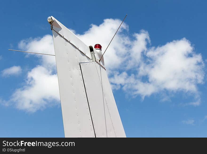 The tail empennage against the sky with clouds. The tail empennage against the sky with clouds